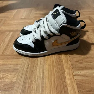 Nike Black and Gold Sneakers with Luxurious Design